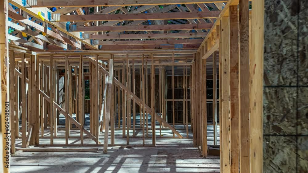 Zooming away from a new construction home, transforming from a bare frame structure to a completed home