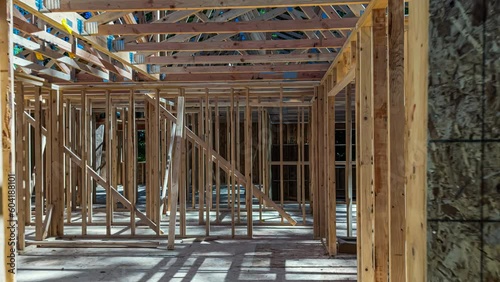 Zooming away from a new construction home, transforming from a bare frame structure to a completed home