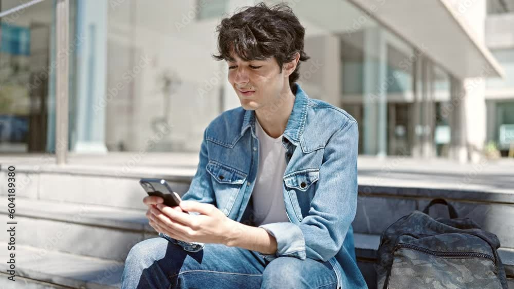 Young hispanic man student using smartphone sitting on stairs at university Young hispanic man student using smartphone sitting on stairs at university