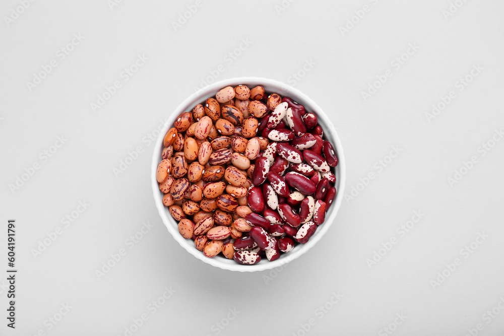 Different kinds of kidney beans in bowl on white background, top view Different kinds of kidney beans in bowl on white background, top view