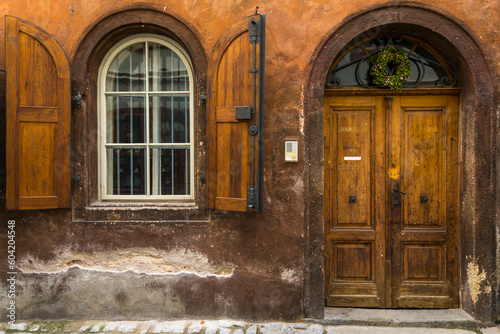 Facade of house with arched window and wooden door in historical center, UNESCO World Heritage Site, Cesky Krumlov photo