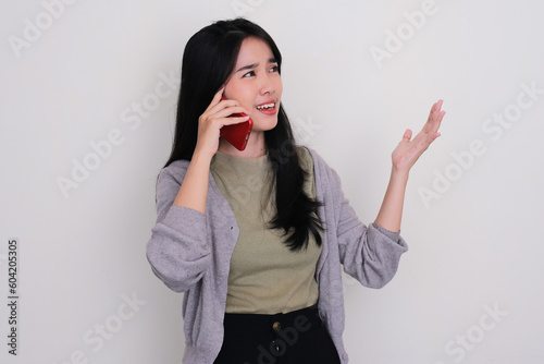 Young Asian women showing angry expression when calling someone photo
