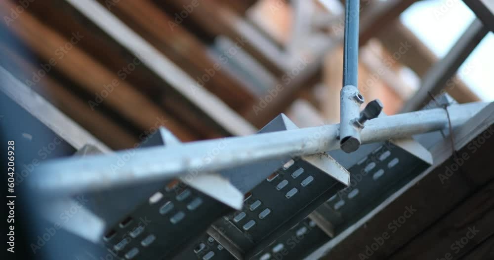 Metal scaffolding at an infrastructure project. The shifting frame of view suggests the dynamism and development of the construction site.