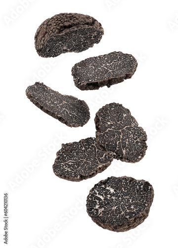 sliced black truffles on white background.