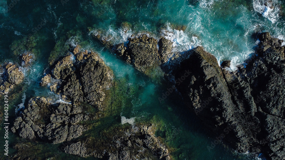 Beach with natural breakwater form by rocks, located at La Playita