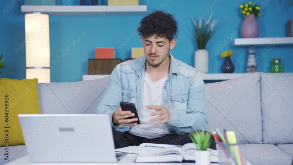 The student looking at the phone panics and looks around. The student looking at the phone panics and looks around.