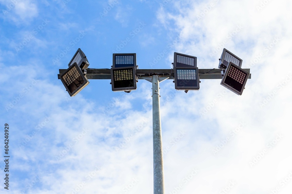 Spotlights on steel pole in stadium with blue sky background. Spotlights on steel pole in stadium with blue sky background.