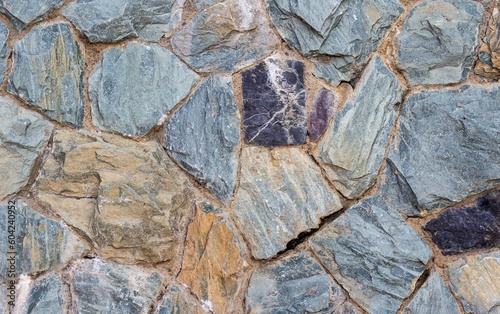 Stone wall for background or texture. Dark pebble stone, granite texture.