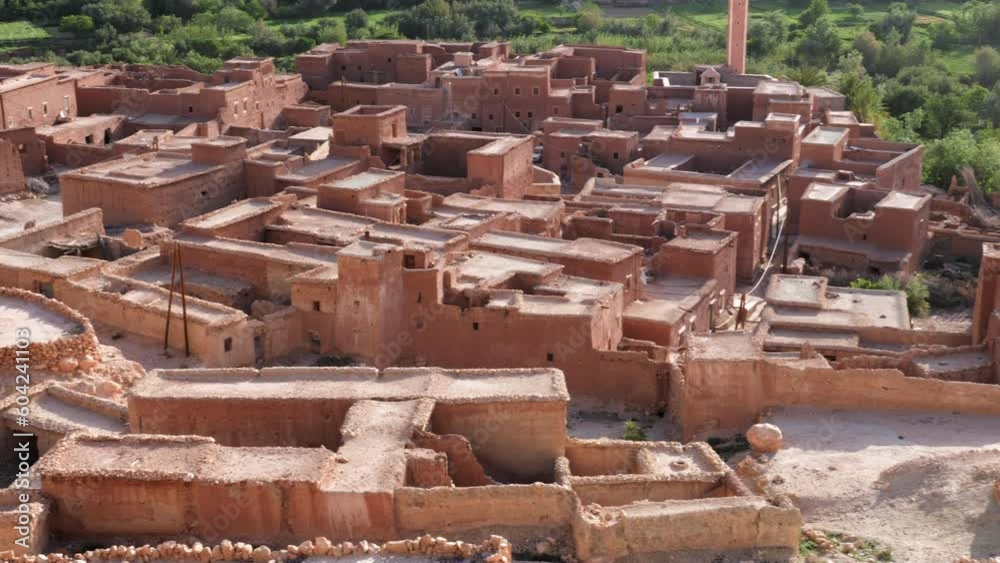 View of a rural village with old clay houses in the High Atlas Mountains, Morocco. Authentic traditional Moroccan country-style architecture. 4k footage.