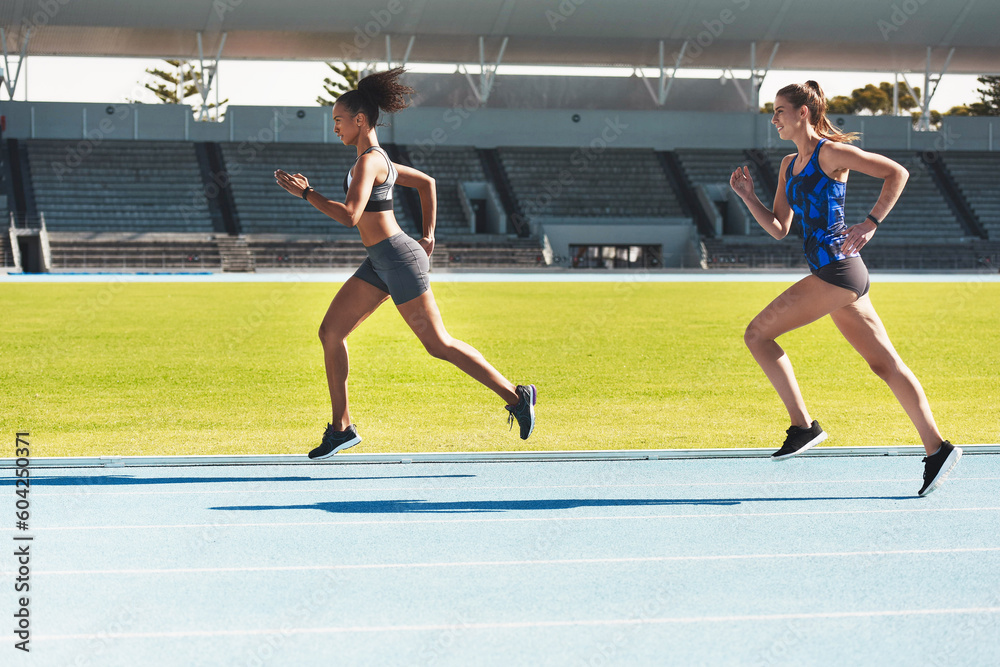 Woman, running and stadium track of athletes in competition, fitness or athletics in the outdoors. Fit, active or sporty women, runner or sprinting in exercise, workout or training for healthy cardio