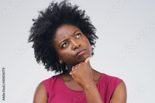 Black woman, thinking and confused in studio with decision or choice on space pr grey background. Doubt, unsure and African female person contemplating, solution and emoji, puzzled and skeptical
