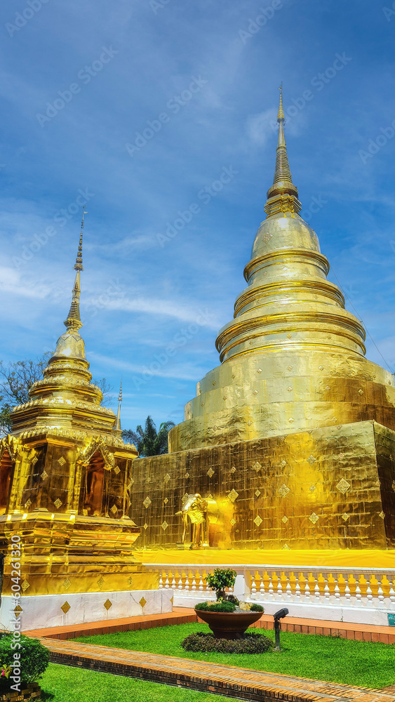 Fototapeta premium Golden stupas inside compound of famous ancient landmark Wat Phra Singh buddhist temple, Chiang Mai, Thailand