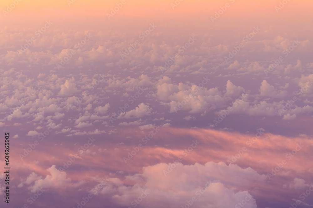 Looking down on pink haze over puffy white clouds at high elevation