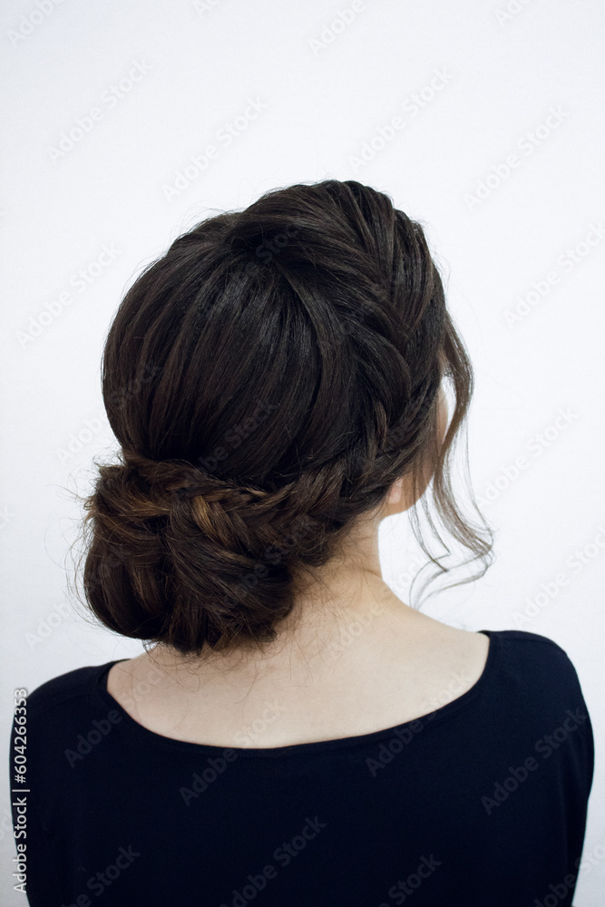 Photo of a stylish female hairstyle, on the back of the girl's head. Image for your creative decoration or design. Photo of a stylish female hairstyle, on the back of the girl's head. Image for your creative decoration or design.