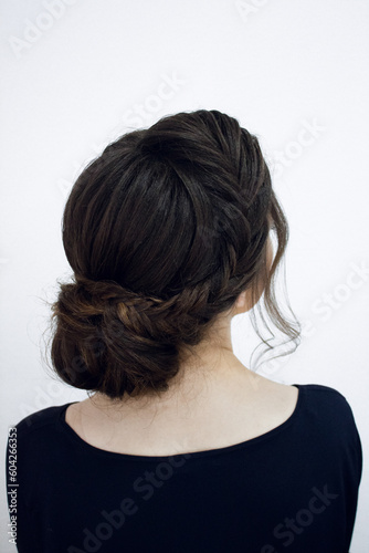 Photo of a stylish female hairstyle, on the back of the girl's head. Image for your creative decoration or design.