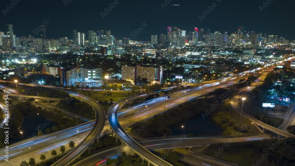 Aerial view of american highway junction at night with fast driving vehicles in Miami, Florida. Time lapse of USA transportation infrastructure Aerial view of american highway junction at night with fast driving vehicles in Miami, Florida. Time lapse of USA transportation infrastructure