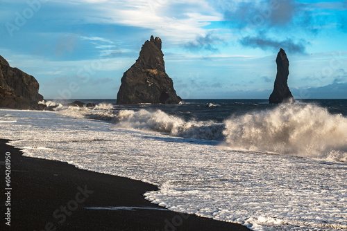 Mighty ocean waves crashing against the Reynisdrangar basalt sea stacks und on the black sand of Reynisfjara beach, near Vík í Mýrdal, Southern Region, Iceland