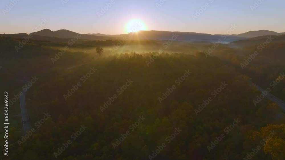 Aerial view of Appalachian mountain hills with brightly illuminated lush and pine woods at fall season. Autumnal landscape of beautiful nature at sunset Aerial view of Appalachian mountain hills with brightly illuminated lush and pine woods at fall season. Autumnal landscape of beautiful nature at sunset