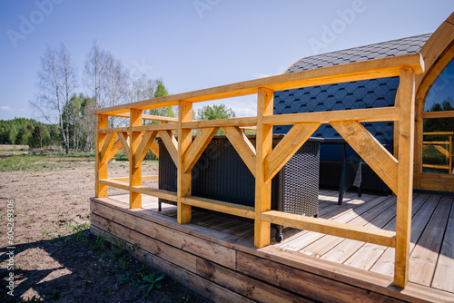 Igloo sauna made of wood with a boardwalk by the lake © Raivo