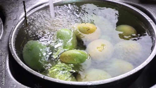 Mangoes fruit washing in sink