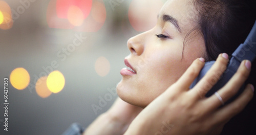 Woman with headphones in city, peace and listening to music, freedom and technology outdoor. Mockup space, podcast or radio streaming with satisfied female person in urban street and audio playlist