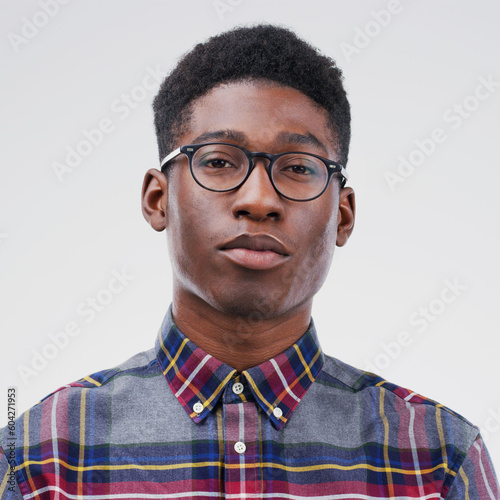 Face portrait, serious nerd and black man in studio isolated on white background. African, geek and male person with glasses from South Africa with fashion, style and pose with clothes for confidence