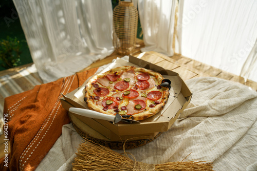 Juicy, fragrant delicious pizza on the table on a sunny day