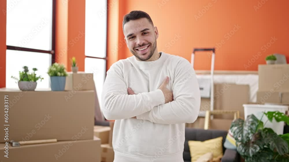 Young hispanic man smiling confident standing with arms crossed gesture at new home Young hispanic man smiling confident standing with arms crossed gesture at new home