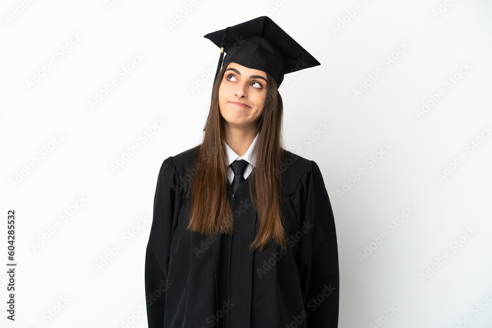 Young university graduate isolated on white background and looking up Young university graduate isolated on white background and looking up