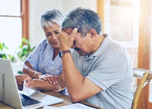 Debt, stress and senior couple with finance bills, paperwork and insurance documents on laptop. Retirement, anxiety and elderly man and woman worry for mortgage payment, investment and budget at home photo
