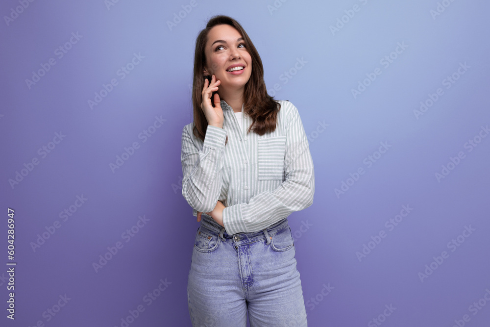 pretty young brunette woman in shirt chatting on the phone on studio background pretty young brunette woman in shirt chatting on the phone on studio background