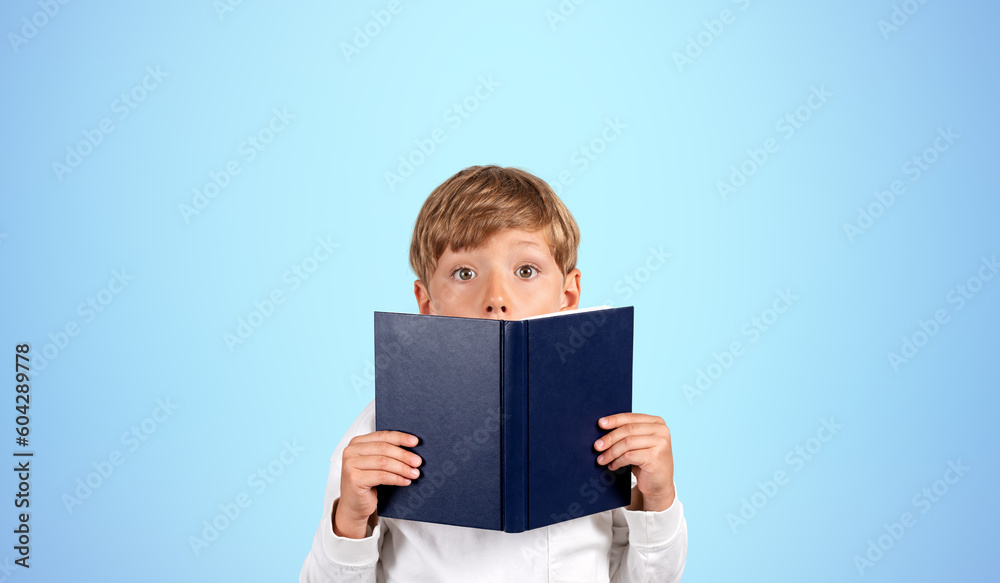 Astonished schoolboy with book, blue Astonished schoolboy with book, blue