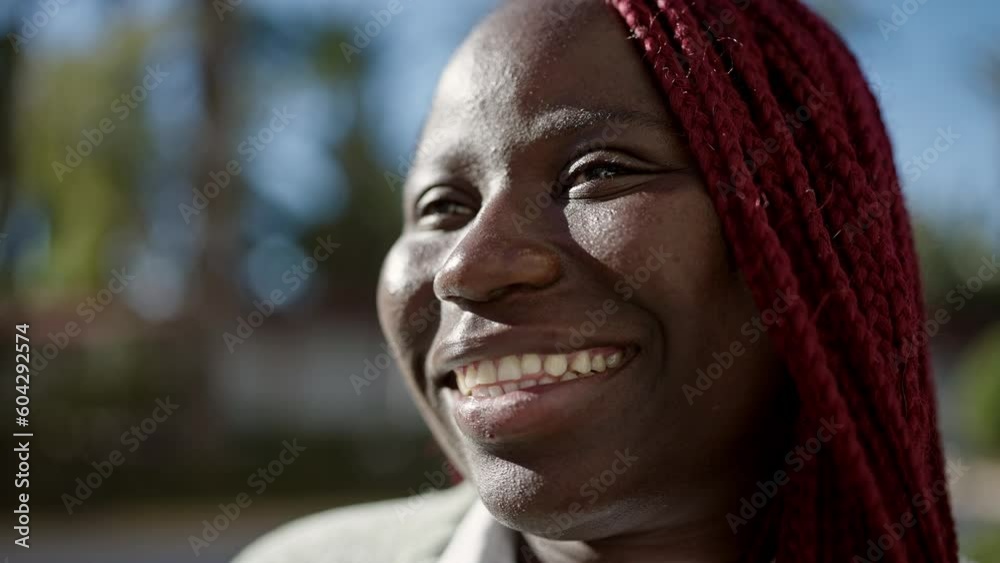 African woman with braided hair smiling confident at street African woman with braided hair smiling confident at street