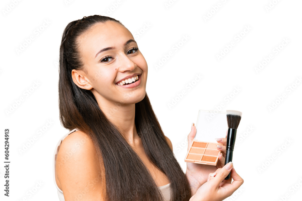 Young Arabian woman over isolated chroma key background with makeup palette and happy Young Arabian woman over isolated chroma key background with makeup palette and happy