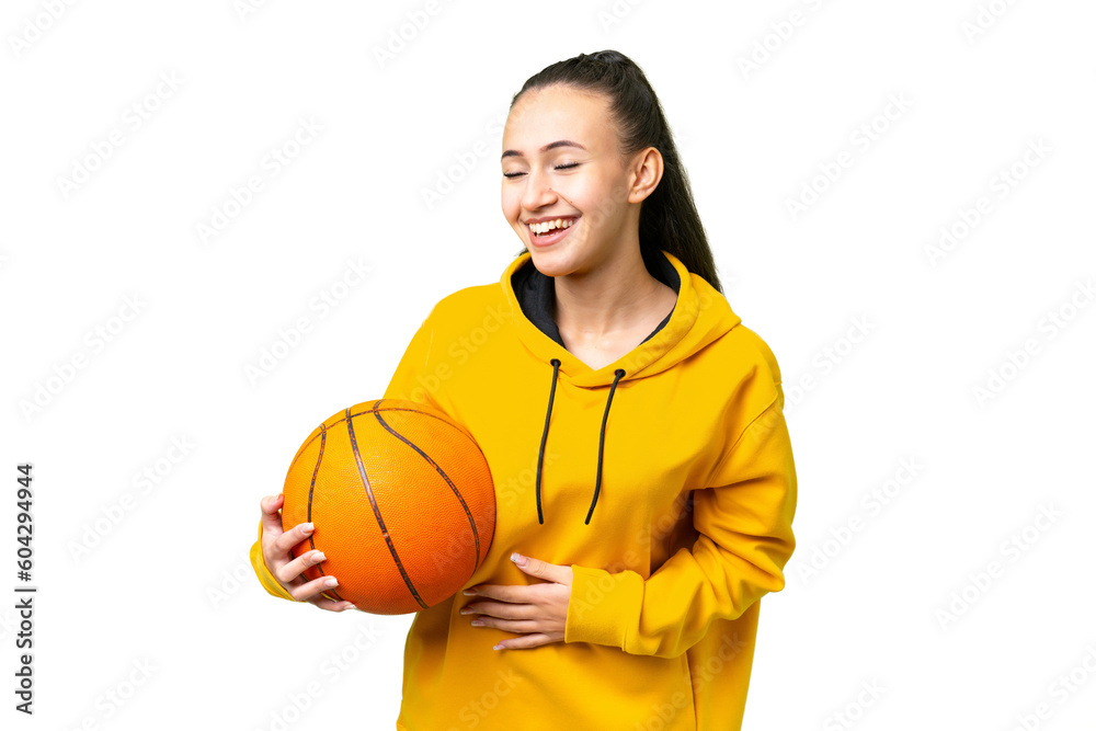 Young Arabian woman playing basketball over isolated wall  over isolated chroma key background smiling a lot