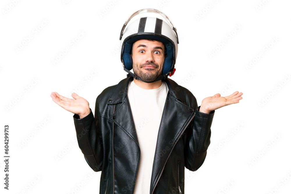 Young caucasian man with a motorcycle helmet over isolated chroma key background having doubts while raising hands Young caucasian man with a motorcycle helmet over isolated chroma key background having doubts while raising hands