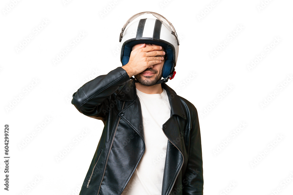 Young caucasian man with a motorcycle helmet over isolated chroma key background covering eyes by hands. Do not want to see something Young caucasian man with a motorcycle helmet over isolated chroma key background covering eyes by hands. Do not want to see something