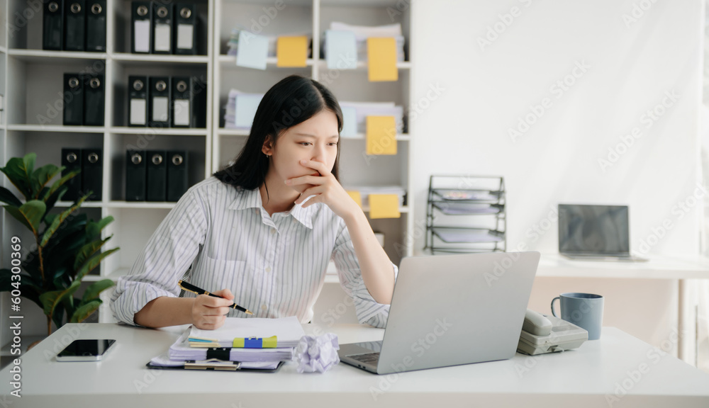 Woman who is tired and overthinking from working with tablet and laptop at modern office. Woman who is tired and overthinking from working with tablet and laptop at modern office.