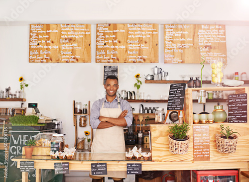 Black man, portrait and owner with arms crossed in cafe with pride for career or job. Barista, smile and confidence of African person from Nigeria in restaurant, small business and coffee shop.