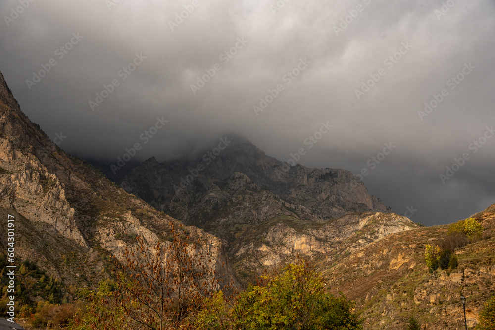 Panoramic view of a typical mountain landscape of northern Spain, nature view with a big rocky mountain in the middle surrounded by lots of vegetation on a cloudy day in Huesca Panoramic view of a typical mountain landscape of northern Spain, nature view with a big rocky mountain in the middle surrounded by lots of vegetation on a cloudy day in Huesca