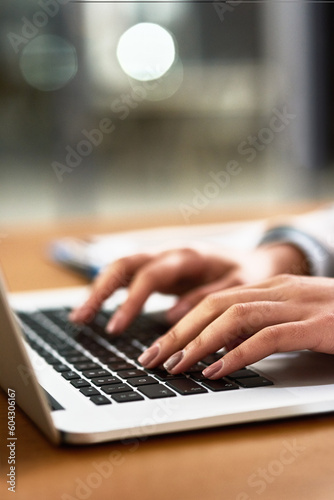 Laptop, keyboard and hands of a person at desk for work, internet and connection at night. Business, closeup and a secretary or receptionist typing on a computer for late admin online in an office