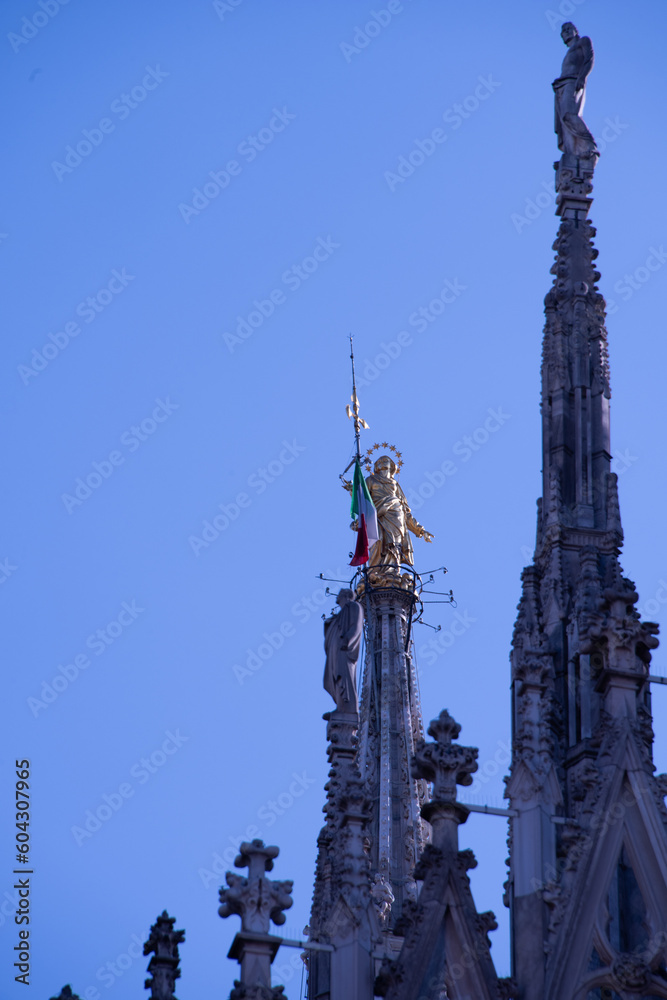 Madonnina statue on the famous Milan Cathedral (Duomo di Milano) on piazza in Milan, Italy Madonnina statue on the famous Milan Cathedral (Duomo di Milano) on piazza in Milan, Italy