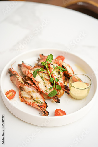 Grilled shrimp and sauce in a white plate
