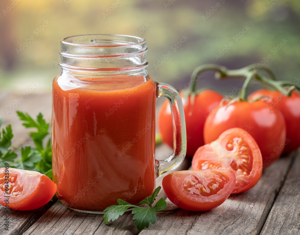 Glass of nutritious tomato juice and fresh tomatoes Glass of nutritious tomato juice and fresh tomatoes