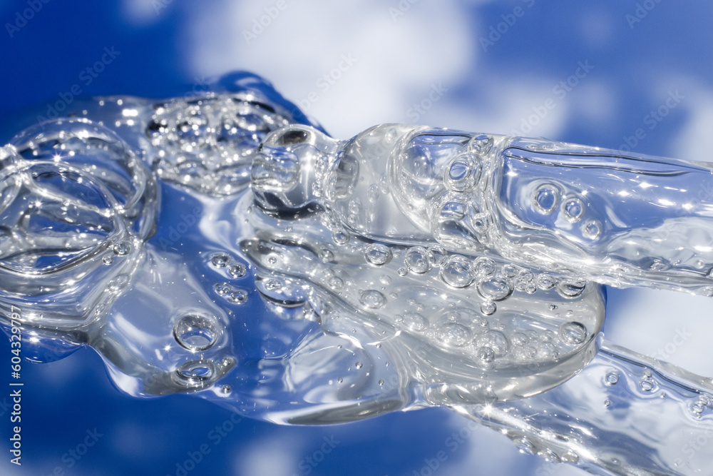 Spilled transparent bubbly gel in close-up. Leaking out of the pipette. Spilled transparent bubbly gel in close-up. Leaking out of the pipette.