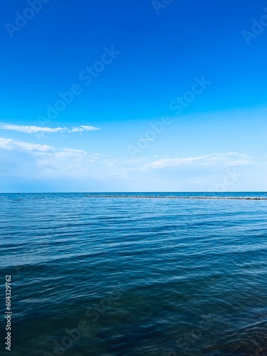 Transparent sea water, blue sea horizon, blue sky 