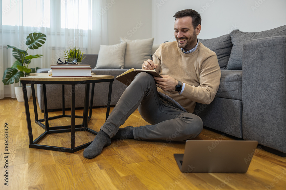 Young freelancer is smiling, working in nice modern home Young freelancer is smiling, working in nice modern home