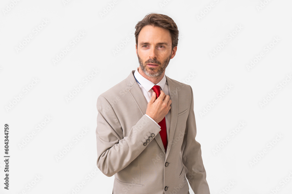 Handsome male model posing wearing a silver suit and a red tie. Handsome male model posing wearing a silver suit and a red tie.