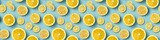 Creative food summer citrus fruits banner panorama wallpaper, seamless pattern texture - Top view of many fresh lemon slices, isolated on blue background (Generative Ai)