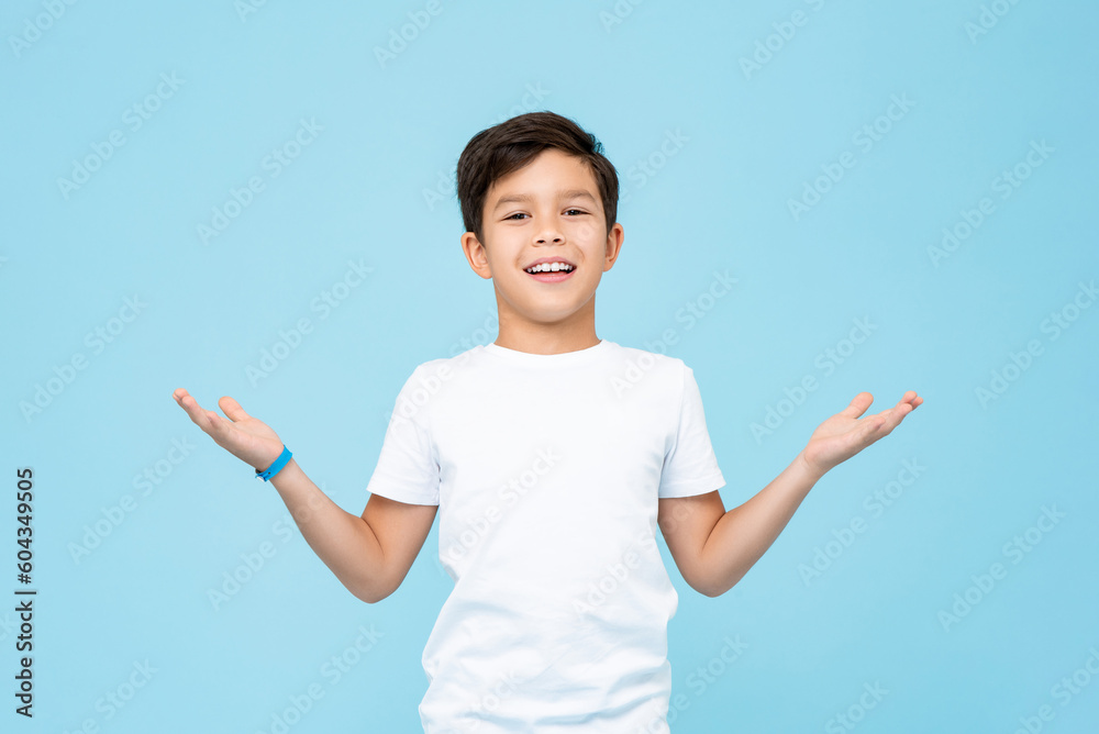 Cute mixed race boy smiling and opening hands doing welcome gestgure in light blue color isolated background studio shot Cute mixed race boy smiling and opening hands doing welcome gestgure in light blue color isolated background studio shot